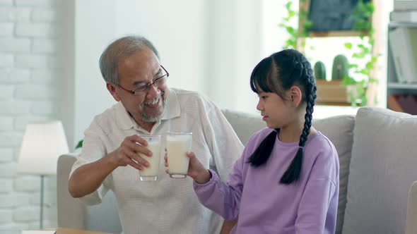 Happy asian elderly and Kid drinking fresh milk for good health with calcium