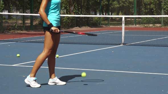 Legs of Woman Beating Tennis Racket on Ball Near Net on Court