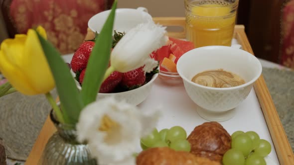 Close Up of a Wood Tray with Breakfast Man Put Sugar in the Coffee