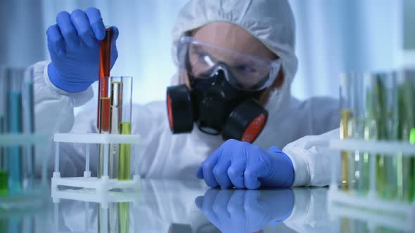 Male Chemist Checking Test Tubes With Biohazard Substance, Toxicology Testing