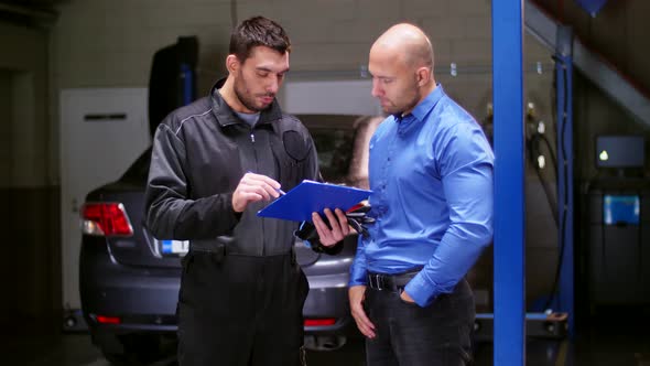 Mechanic and Customer Shaking Hands at Car Service