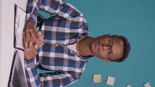 Vertical Video POV of Employee Attending Video Call Conference at Desk