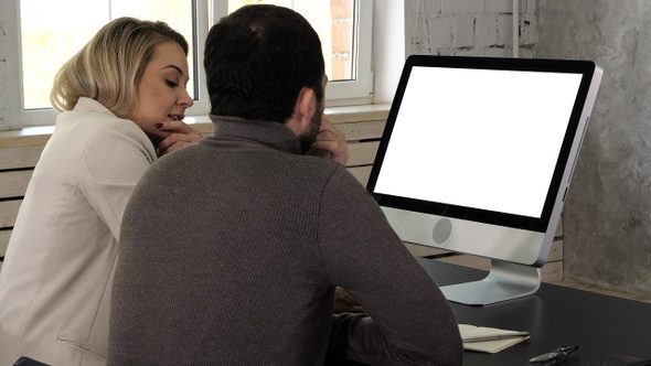 Businesspeople co-working comparing a desktop computer