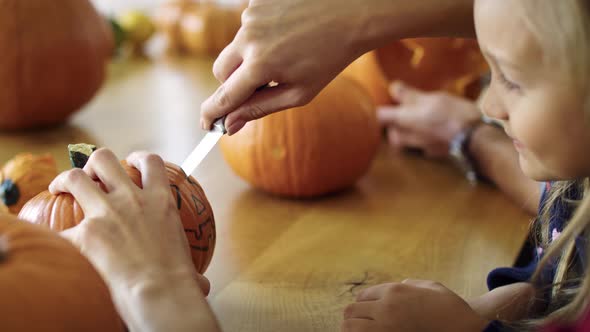 Drilling small pumpkins for Halloween