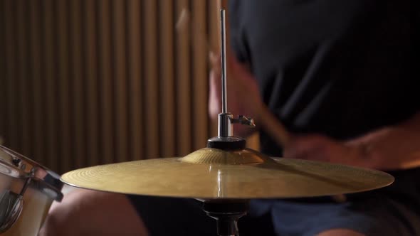 Slowmotion Drummer Plays Sticks on a Drum Kit Setting the Rhythm
