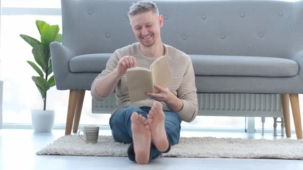 Man Reading Book and Laughing