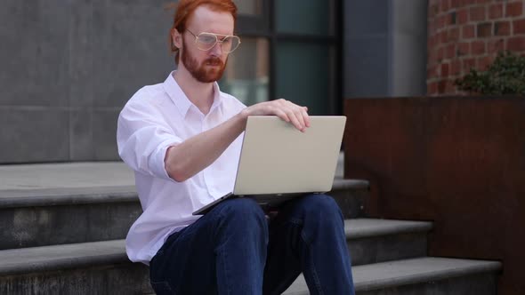 Designer Leaving After Sitting on Stairs and Working on Laptop