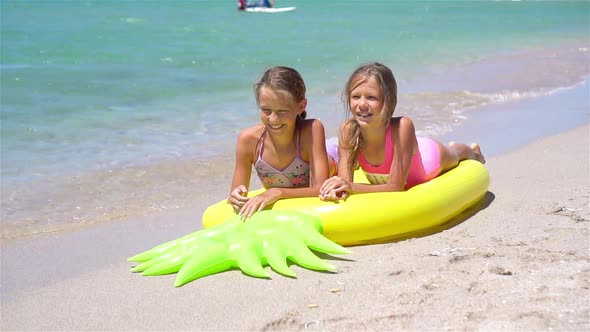 Little Girls Having Fun at Tropical Beach During Summer Vacation Playing Together