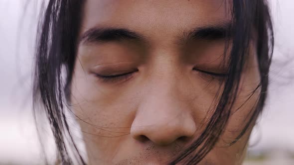 Closeup of Asian young man with eyes closed