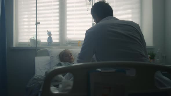 Pediatrician Examining Little Patient in Hospital Ward