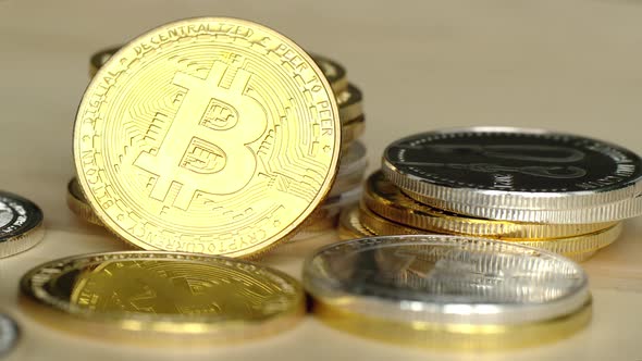 Woman playing with crypto coins with golden bitcoin, close up