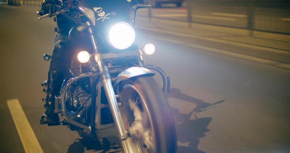 Close Up to Cool Motorcycle Details Wheel and Lights Driving Fast at Night