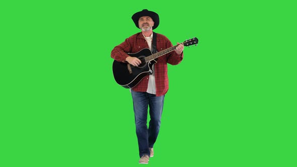 Elder Cowboy Walking Singing and Playing Guitar on a Green Screen Chroma Key