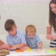 Young Parents Teaching Their Little Boys How To Make Cookies - VideoHive Item for Sale