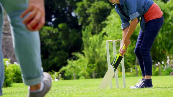 Couple playing cricket