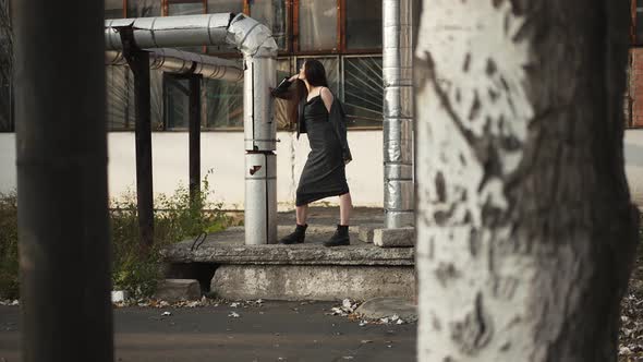 Model Posing Near Old Pipes