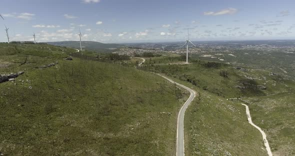 Wind Turbines Spinning On The Lush Mountains In Reguengo Do Fetal, Batalha, Portugal On A Sunny Day