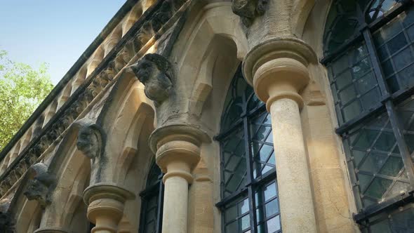 Passing Pillars And Gargoyles On Old Classical Building
