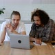 Two Young Freelance Guys Work Remotely At Home on an Online Project, Using a Laptop and a Tablet - VideoHive Item for Sale