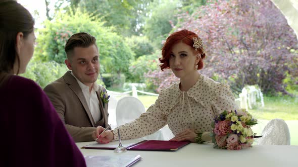 Newly Made Bride Sign Marriage Agreement Ceremony with Beautiful Redhair