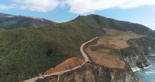 Aerial Drone Stock Video of Bixby Bridge Highway with water and shore below in Big Sur Monterrey Cal