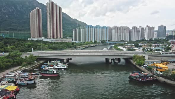 Hong Kong MTR Light Rail passing over bridge spanning Tuen Mun river