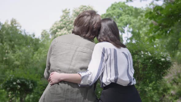 Portrait of a Young Happy Couple in Casual Clothes Spending Time Together in the Park, Having a Date