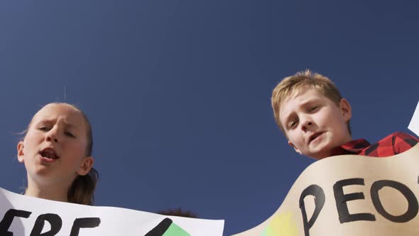 Group of kids with climate change signs in a protest