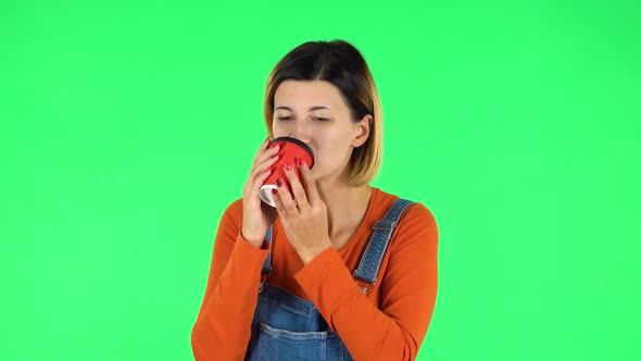 Cheerful Young Woman Enjoying Coffee on Green Screen