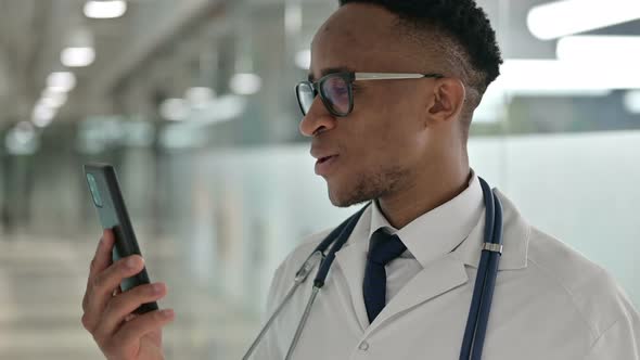 Portrait of Male African Doctor Doing Video Call on Smartphone 