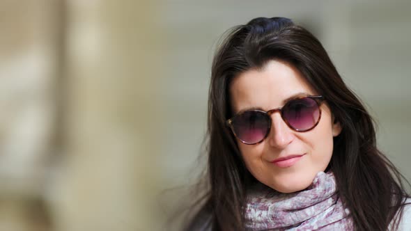 Pretty Brunette European Woman Posing in Stylish Modern Sunglasses Smiling and Looking at Camera