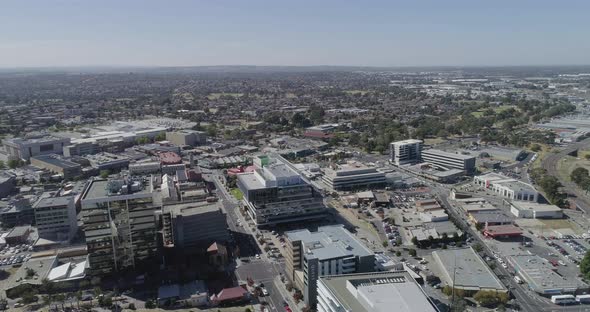 Impressive aerial perspective of inner Dandenong City flying over new and old developments on summer