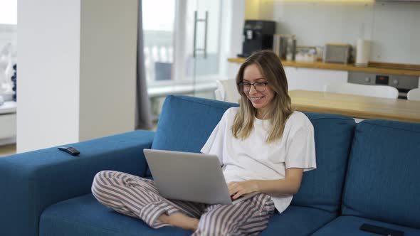 Blonde Woman Make Video Call Online Chat Look at Laptop Screen Sit on Sofa