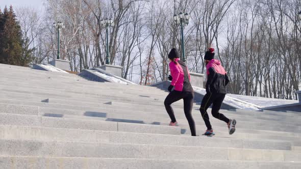 Fit People Jogging on Staircase on Winter Day