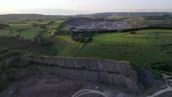 Late afternoon flight over a limestone quarry in Derbyshire flying towards another one.