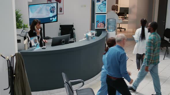 Diverse People and Mother with Child Waiting in Hospital Reception