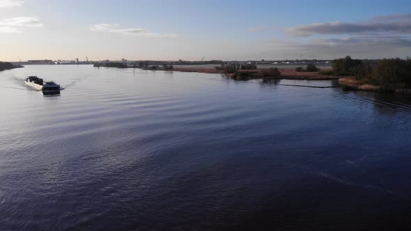 Freight Carrier Ship On Oude Maas River During Sunset In South Holland, Netherlands. - Aerial Shot