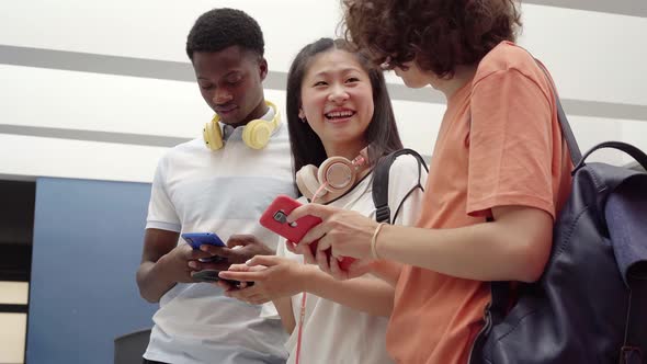 Group of Students of Different Races Using a Cell Phone