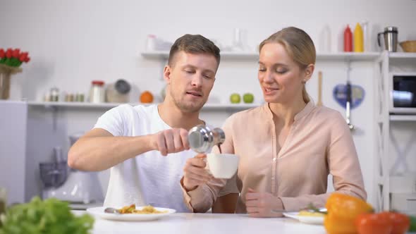 Handsome Man Pouring Brewed Coffee to Young Lady, Energy Boost in Morning