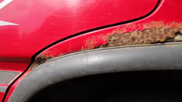 Nasty rust, corrosion on a red cars wheel arches