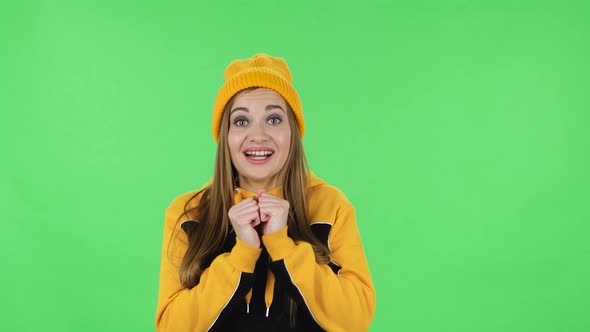 Portrait of Modern Girl in Yellow Hat Is Looking at Camera with Anticipation, Then Very Upset