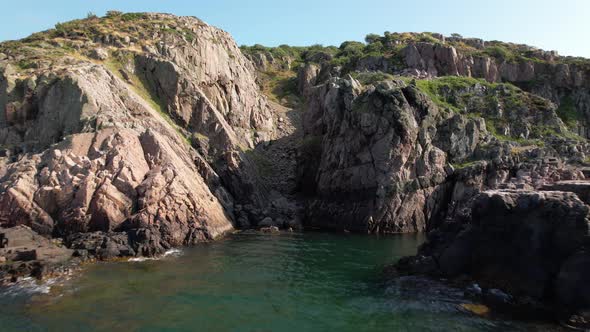 Flying towards and close to cliffs, raising between the cliffs in the end at Kullaberg, Sweden