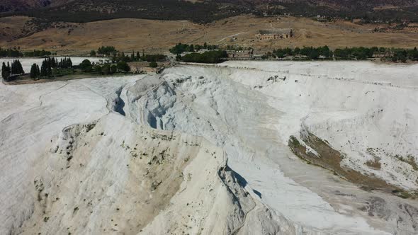 aerial top down view of a unique white mineral rich mountain in Pamukkale Turkey famous for its ther