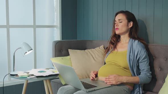 Closeup Belly Mother Relaxing After Working Day. Pregnant Mother Holding Tummy