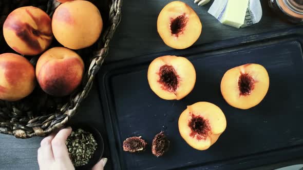 Cutting peaches in half for making grilled peaches.