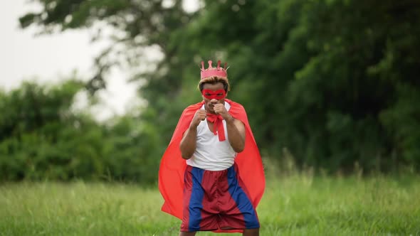 Hero man in red with crown standing and punching air