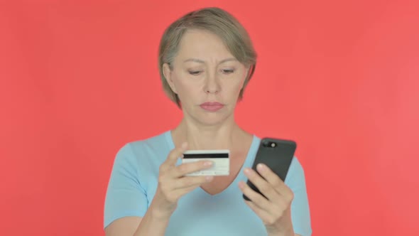 Old Woman Shopping Online Via Smartphone on Red Background