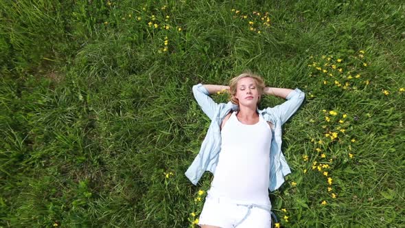 Expecting Young Mother Relaxing in Grass