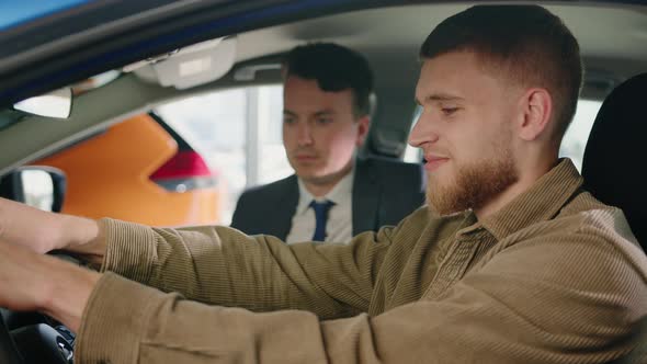 The Manager Sits in the Car with the Customers During the Test Drive