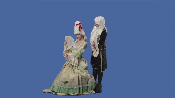 Portrait of Courtier Lady and Gentleman in Historical Vintage Costumes and Wig is Waving a Fan